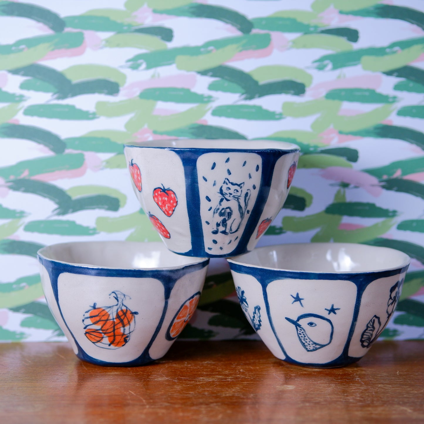 Delicate handmade and hand painted ceramic bowls: oranges, cat with strawberries and birds with flowers