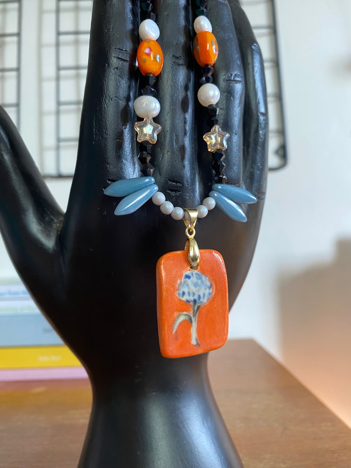 Dandelion orange and blue ceramic charm necklace with freshwater pearls and glass beads